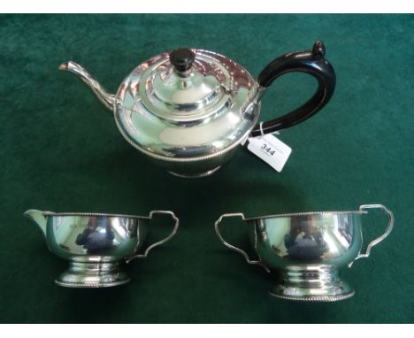 A three piece silver tea service, comprising: teapot, twin handled sugar bowl and cream jug, Birmingham hallmarks, 1931.