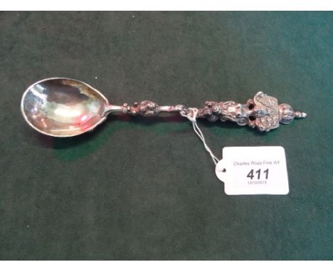 An ornate silver spoon, having Royal Crest finial and shaped bowl.