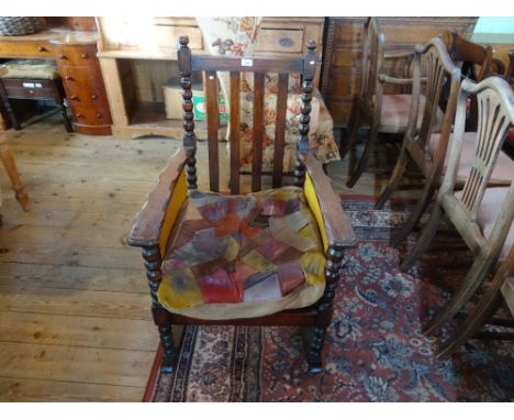 A Victorian oak stick back rocking armchair, in the Arts & Crafts style.