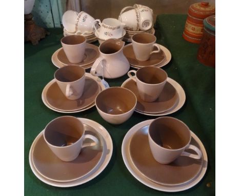 A late 20th century Poole Pottery part-tea service, comprising: six trios, milk jug and sugar bowl, blue printed mark to base