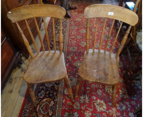 A pair of stick back kitchen chairs.