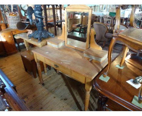 A mid-20th century pine dressing table, having swivel mirror over single drawer on turned supports, terminating in castors, 1