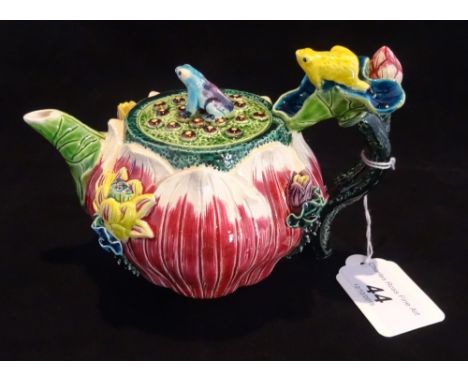 A 20th century Taiwan-Cochin ceramic teapot, profusely decorated in the form of a folded lotus leaf with applied flower and f