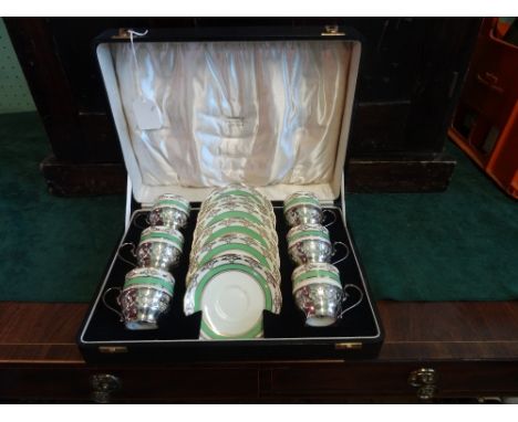 A cased set of Royal Albert coffee cans and saucers, the cans in pierced silver holders, the box bearing the name Oldfield Li