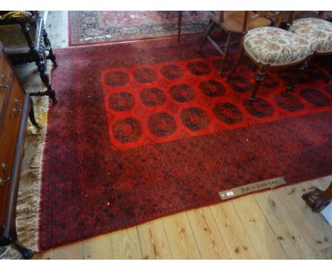 A large 20th century machine made carpet, decorated throughout with geometric shapes, 300cm x 200cm.