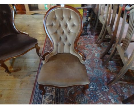 A reproduction mahogany button back upholstered ladies chair.