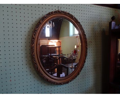 A contemporary oval wall mirror in gilt frame, 47cm x 36cm.