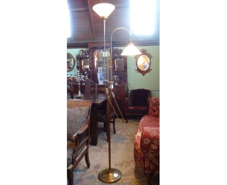 A mid-20th century brass floor standing telescopic reading lamp, with further uplighter on circular foot.