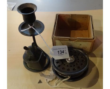 An early 20th century Cummins fishing reel, together with a single spelter candlestick with mouse reading a book.