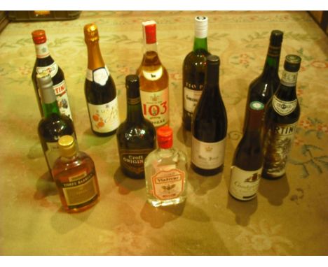 A quantity of twelve miscellaneous wine and spirits, to include: Martini, Vladivar Vodka, Three Barrels Brandy and others.