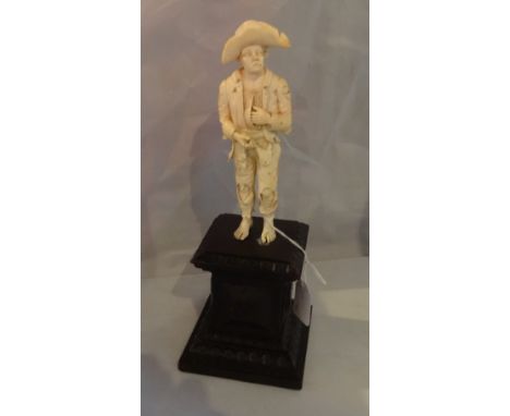 An 18th century ivory figure, Dresden Circle of Wilhelm Kruger, a standing beggar wearing torn  clothes and hat, mounted on a