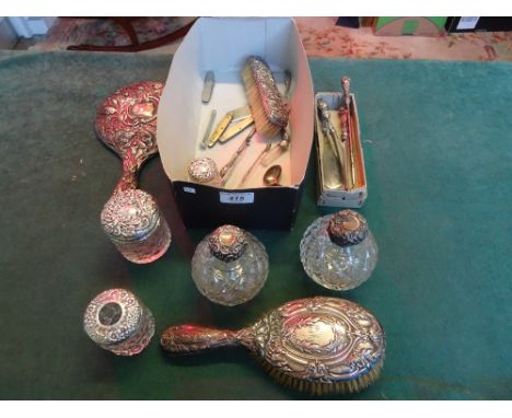 A silver backed dressing table mirror and hairbrush, together with two cut glass scent bottles with silver mounts and other i