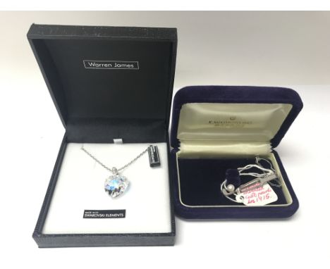 A boxed new Swarovski heart shaped necklace along with a Mikimoto silver golf tie pin with cultured pearl. NO RESERVE.