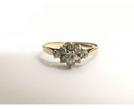 A ladies 9ct yellow gold ring set with nine white stones in diamond formation, ring size K/L. Total weight approx 2 grams. - 
