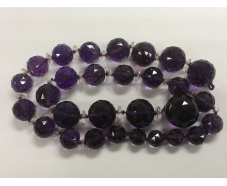 A large amethyst crystal necklace with faceted design.