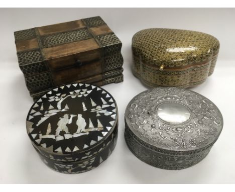 Four boxes comprising an example inlaid with mother of pearl, one of Middle Eastern design and two others. NO RESERVE.