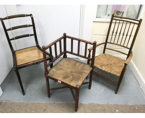 A cane seated chair with carved wood and brass  back rails plus a rush seated bobbin chair and a similar dining chair.NO RESE