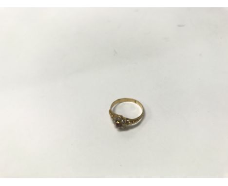 A Victorian 18ct Gold ring set with a central ruby and seed pearl. Ring size J.