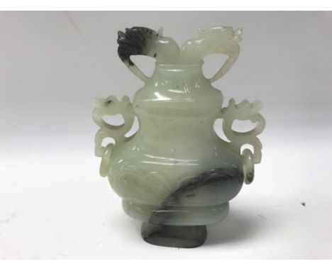 A carved jade type lidded vase of flattened form.Approx 14cm high.