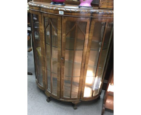 A walnut Display cabinet with a shaped front on ball and claw feet. and a brass fender (2) - NO RESERVE