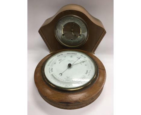 A 1950s mantle clock and a circular wall barometer (2). NO RESERVE.
