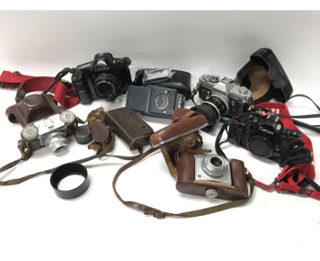 Two camera bags containing a collection of cameras and accessories.