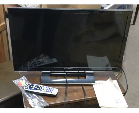 A Sharp 24" TV, model number - LC-24DV250K with Chrome stand.