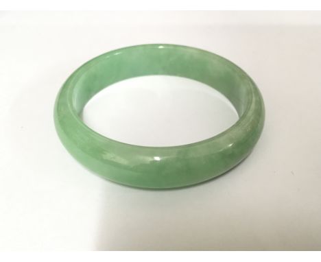 A jade bangle, total weight approx 56 grams.