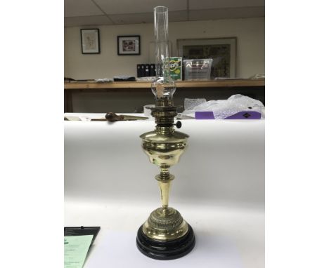 A German brass oil lamp with glass chimney. NO RESERVE.