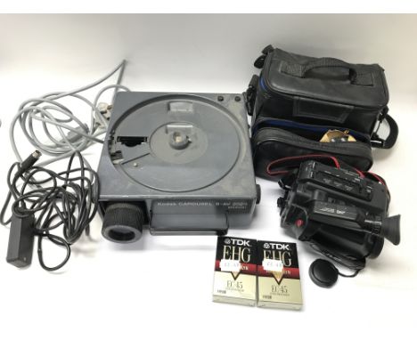 A Kodak Carousel S-AV 2020 projector (missing slide wheel on top), a VHS-C JVC video camera and a tripod. NO RESERVE.