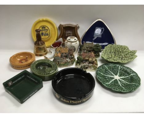 A box of ceramics including breweriana ashtrays and Danbury Mint model buildings.