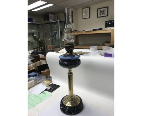 A British brass oil lamp with floral design and glass chimney. NO RESERVE.