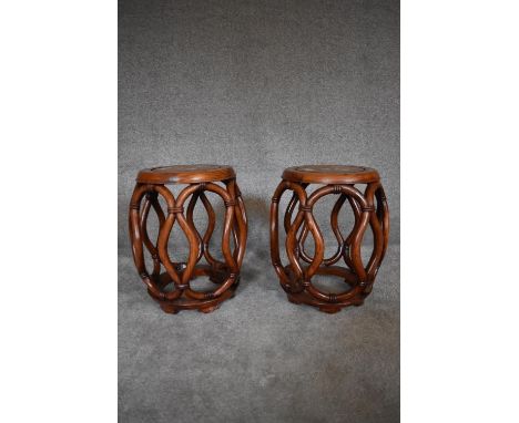 A pair of Chinese rosewood and mother of pearl inlaid barrel shaped stools with latticework sides. H.46 x 30cm 
