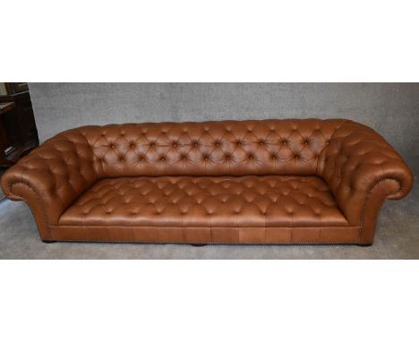A four seater Chesterfield sofa by George Smith upholstered in deep buttoned tan leather. H.65 x 274 x 105cm (the six screw i