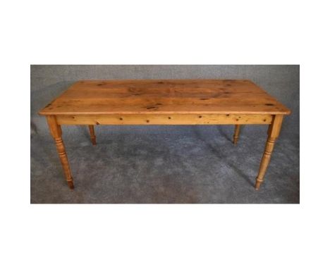 A large 19th century pitch pine kitchen refectory dining table with planked top on ring turned tapering supports table. H.75x