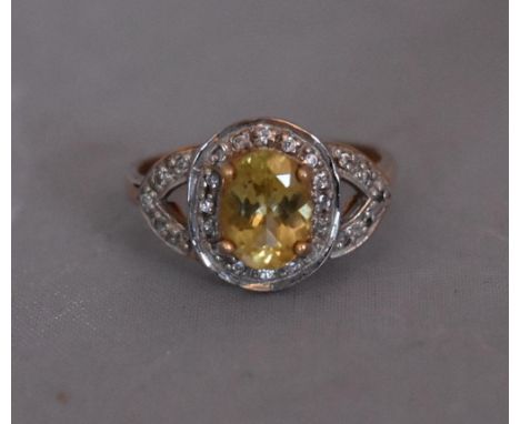 A modern Lemon apatite and zircon cluster ring. Size N / O. Set to centre with an oval mixed cut Lemon Apatite with an approx