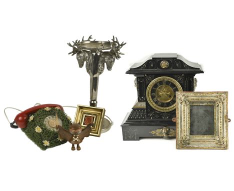 A late 19th century black slate mantel clock, together with a rotary dial telephone decorated with astro turf and faux daisie