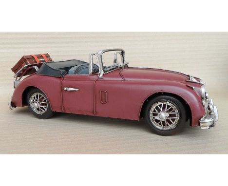 A group of four scale model steel red convertible cars, 10x13x30cm. (4)