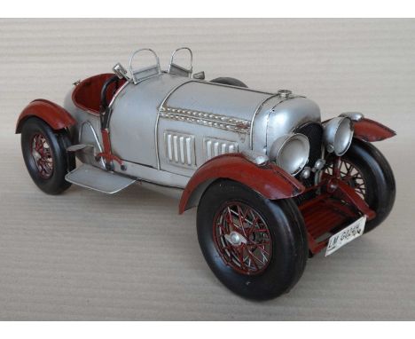 A group of nine scale model silver steel cars, 14x14x34cm. (9)