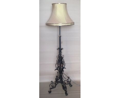 Wrought iron standard lamp and shade.