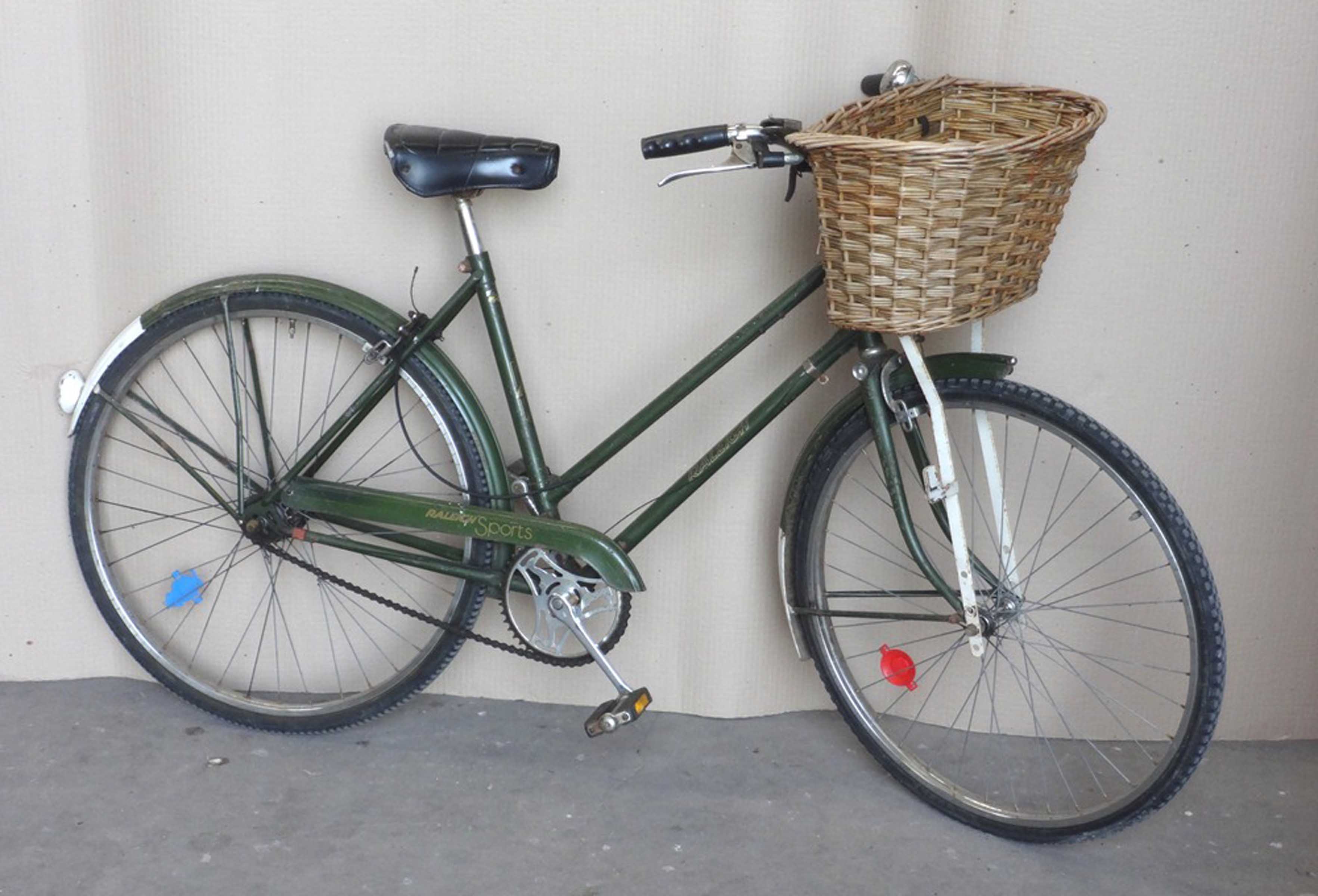 Green 'Raleigh' bike with basket.