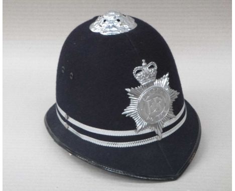 A Policemans helmet,  and five assorted hats, various sizes. 