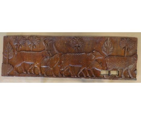 A decorative carved wooden panel