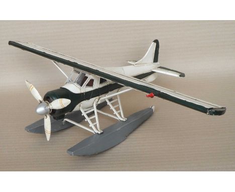 A group of twelve scale model steel white sea planes, 14x52x36cm. (12)