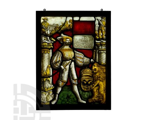 Switzerland, c.1535 AD. A framed stained glass panel depicting a standing Landsknecht standard bearer in half-armour with puf