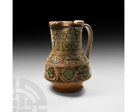 15th-16th century AD. A glazed terracotta pitcher with carinated body, broad neck, trefoil mouth, D-section handle and splaye