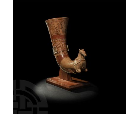 1st millennium BC. A ceramic rhyton with painted decoration and equine finial; the trumpet-shaped mouth with painted bands of