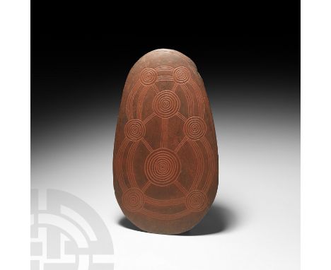 Mid 20th century AD or earlier. A lentoid-section stone totem comprising two faces engraved with different geometric designs,
