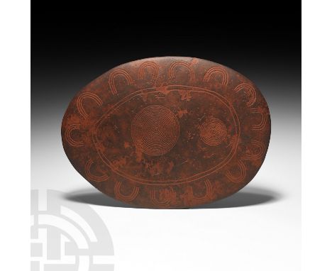 Mid 20th century AD or earlier. A lentoid-section oval schist-like stone totem or churinga engraved using the incisor tooth o