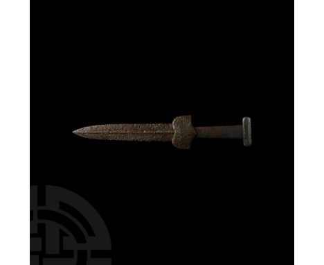 7th-4th century BC. An iron dagger with lozenge-section leaf-shaped blade, double-lobed lower guard, rectangular grip and T-s